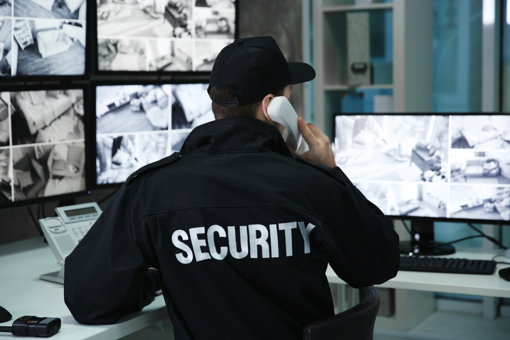 security guards monitoring modern cctv cameras indoors